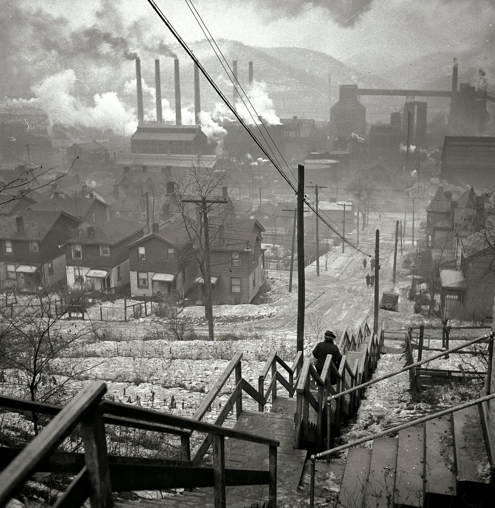 A mill town in winter — a black-and-white documentary photograph.